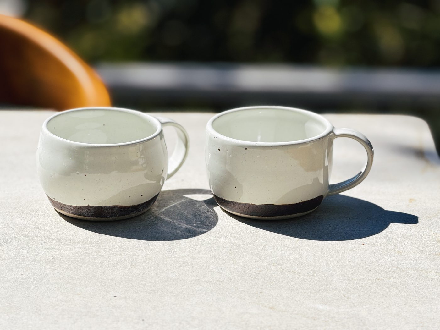 Stoneware large white mugs with brown clay rim and two hearts, handmade by Suzanne Luna
