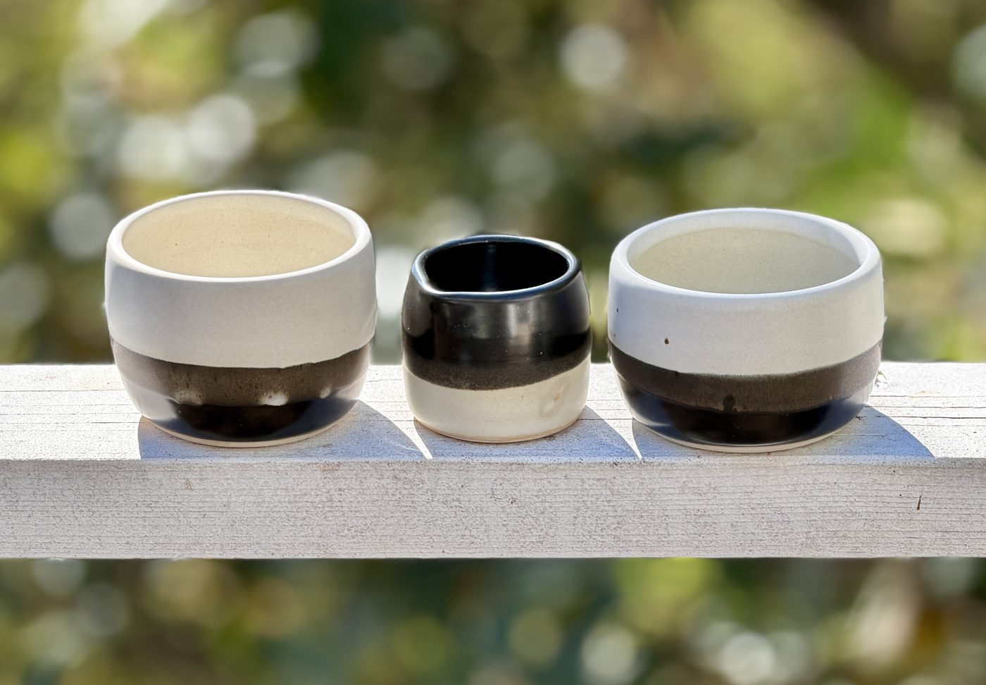 Porcelain handle free “Day to Nite” mugs with night to day creamer, handmade by Suzanne Luna