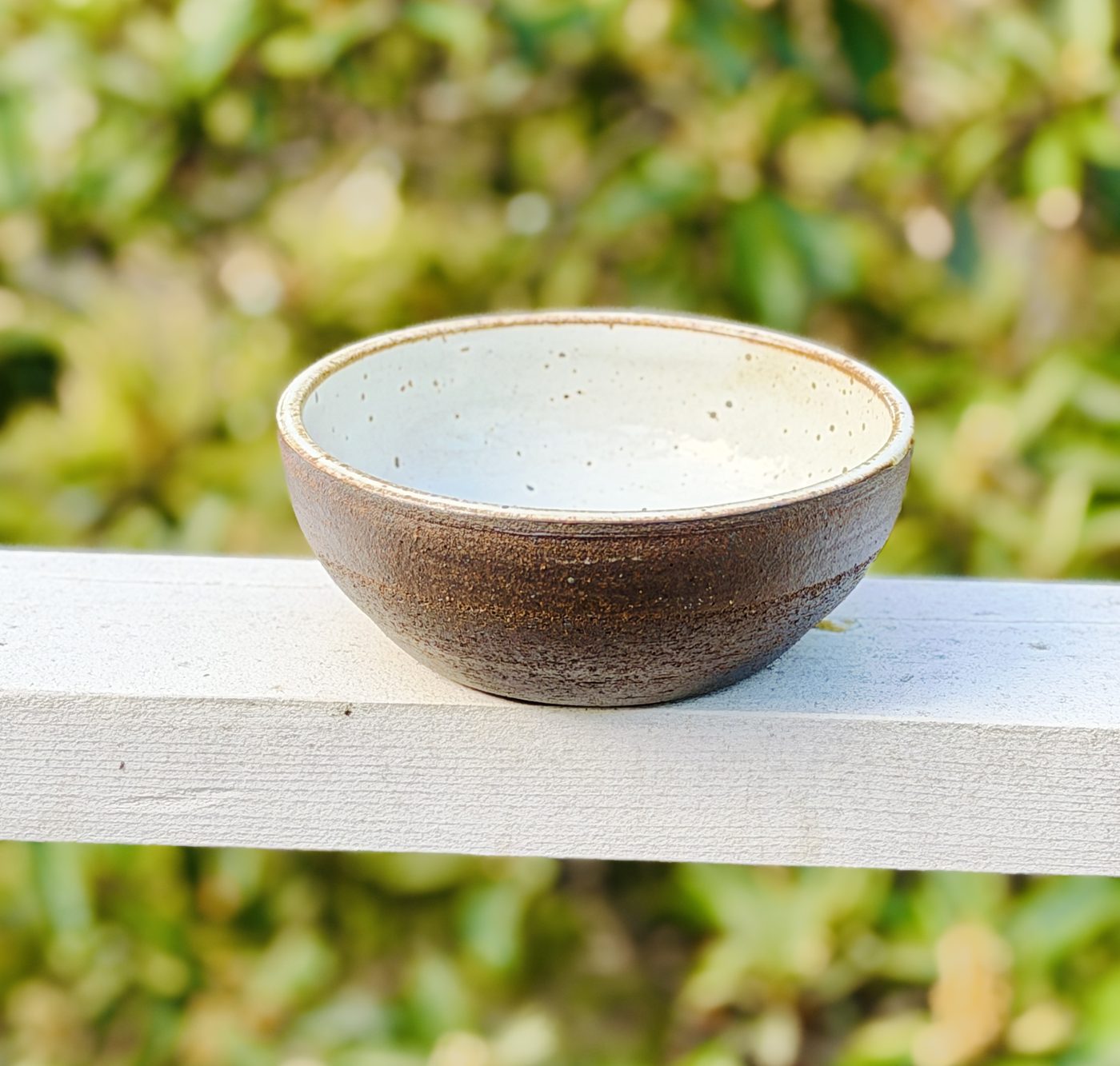 Stoneware medium White speckled int and raw black clay ext., handmade by Suzanne Luna